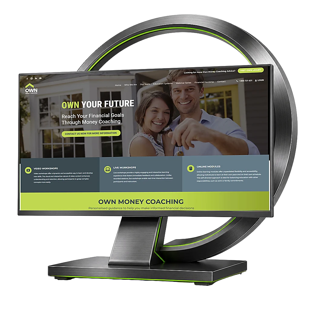 Brushed-metal desktop monitor and sculptural ring displaying the Own Money Coaching website